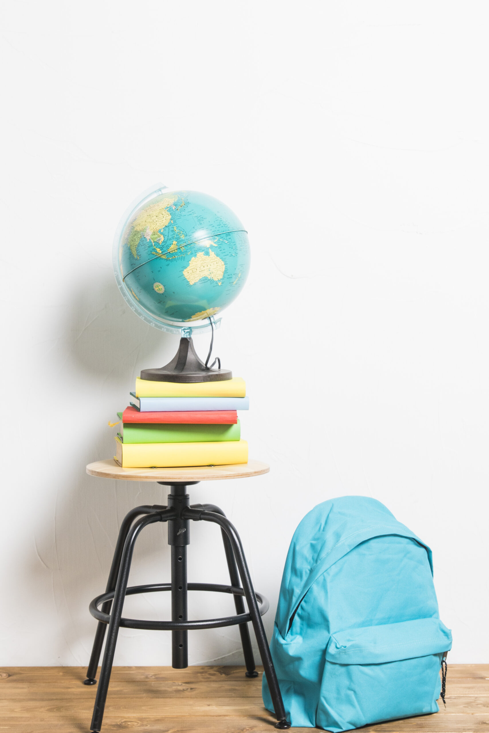 globe books placed stool chair schoolbag